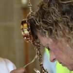 Msgr. Anthony Figueiredo, director of international affairs of the Diocese of Assisi, Italy, blesses pilgrim Natalie Orefice with a relic of the heart of Blessed Carlo Acutis during public veneration Sept. 21, 2024, at St. Anthony’s Church in Manchester,